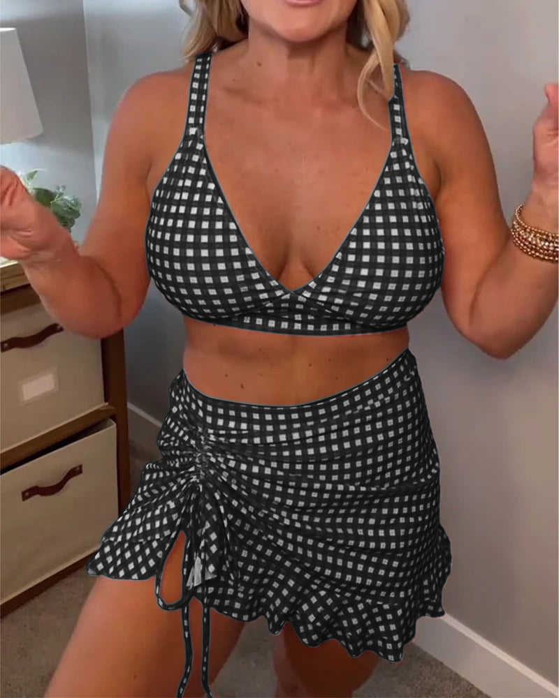Two-piece swimsuit with a relaxed check pattern and straps.