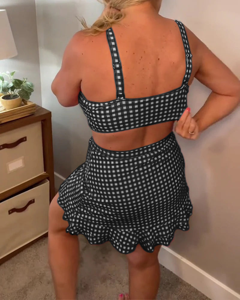 Two-piece swimsuit with a relaxed check pattern and straps.