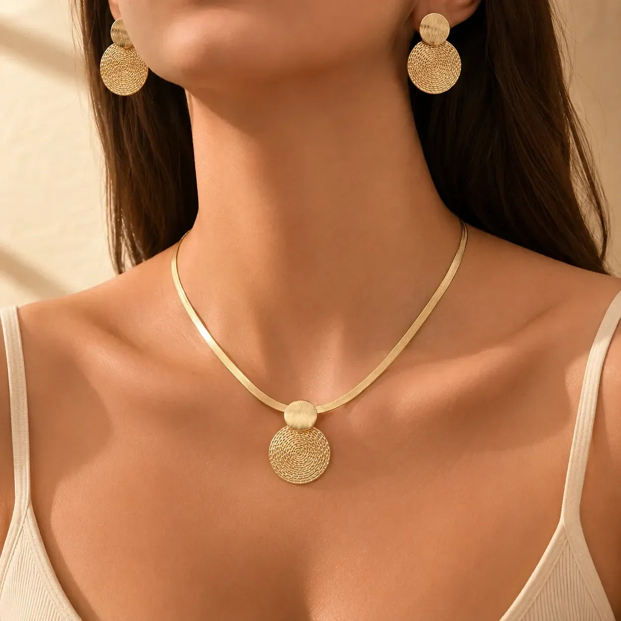 Aurenza – Gold necklace and earring set, textured medallion, flat snake chain